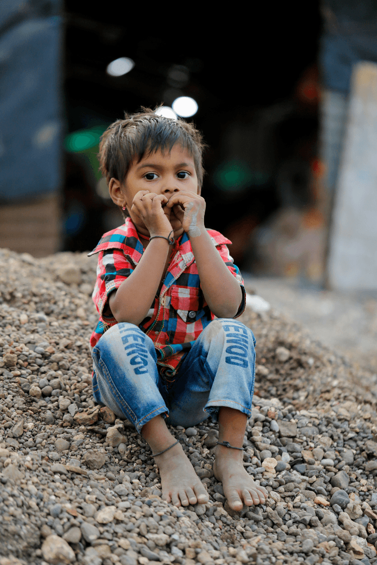 Young boy sitting on rubble
