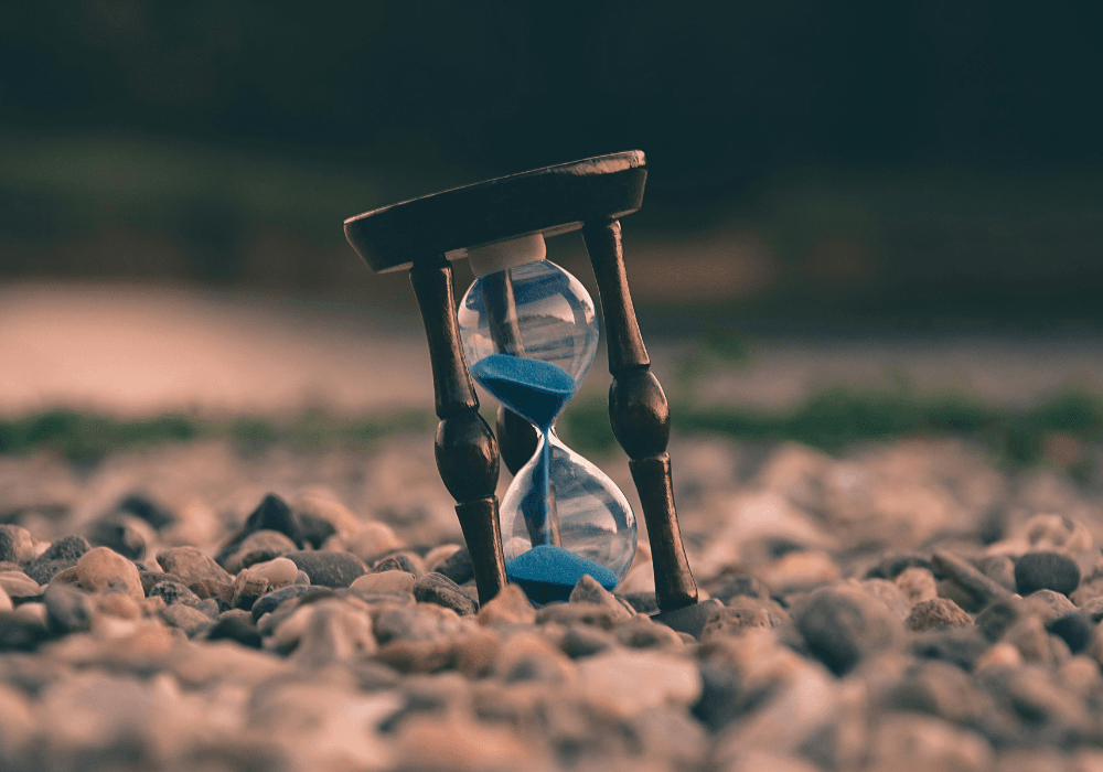 An hourglass - an instrument for measuring time with blue sand