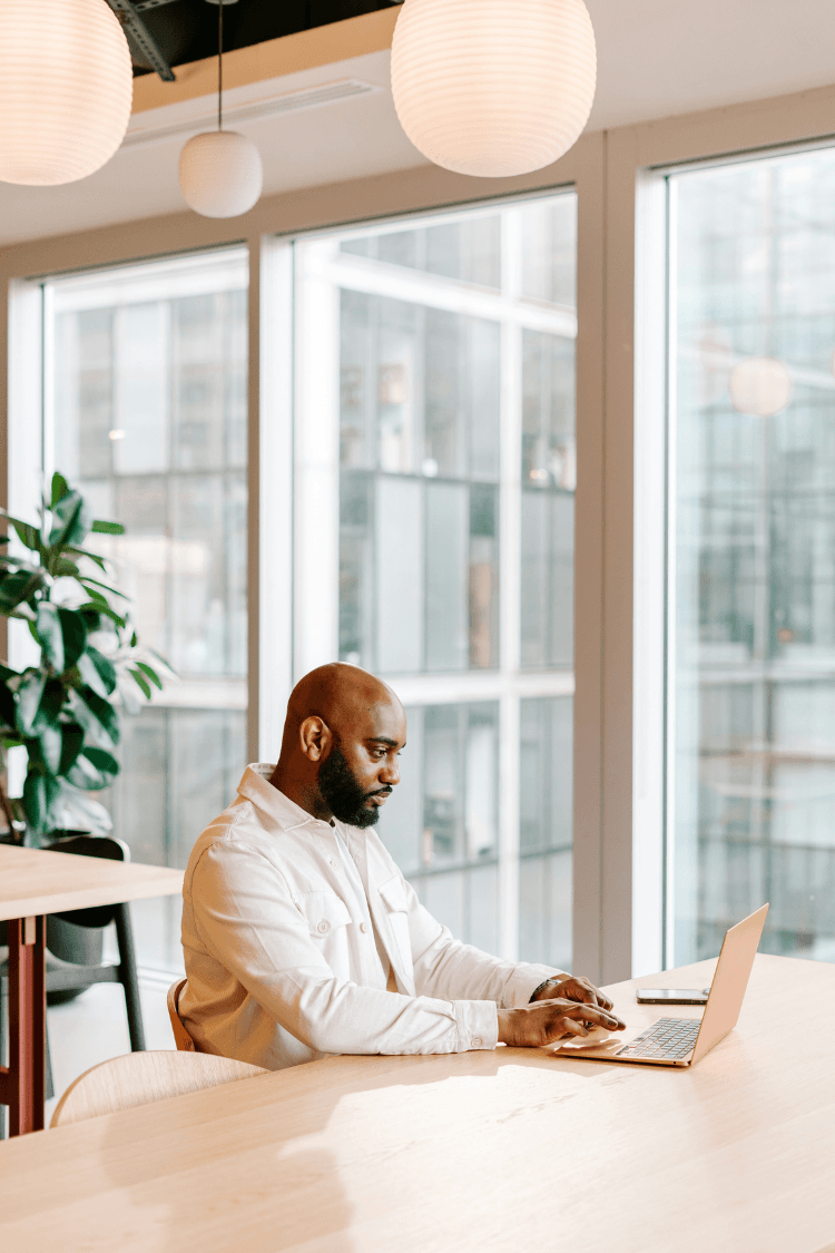 Man in office looking at laptop
