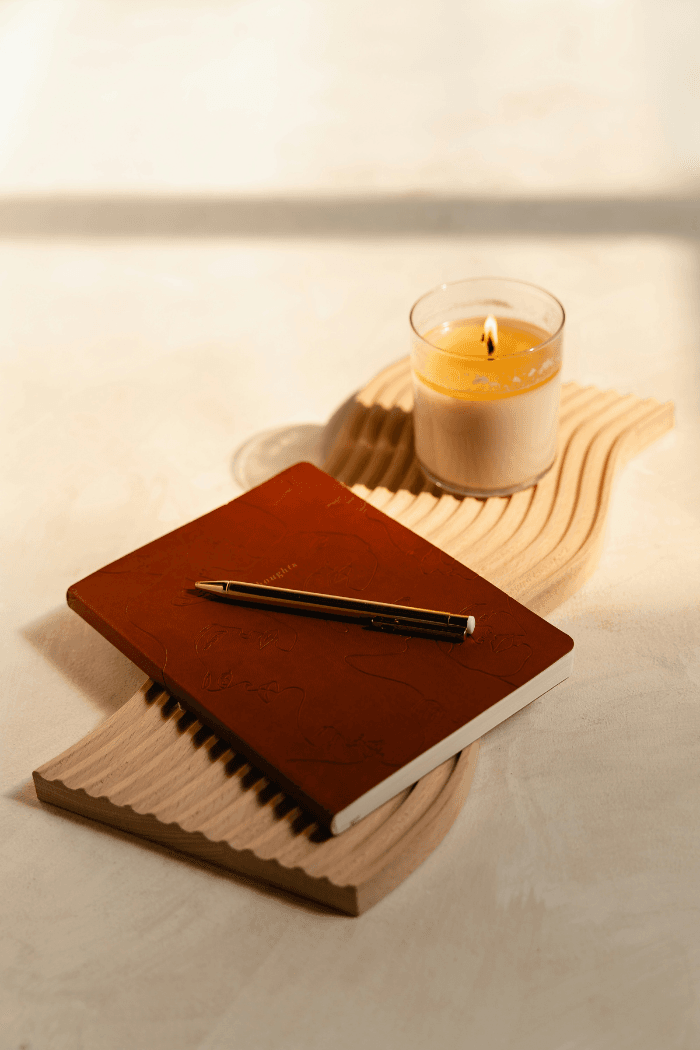 Notebook next to scented candle