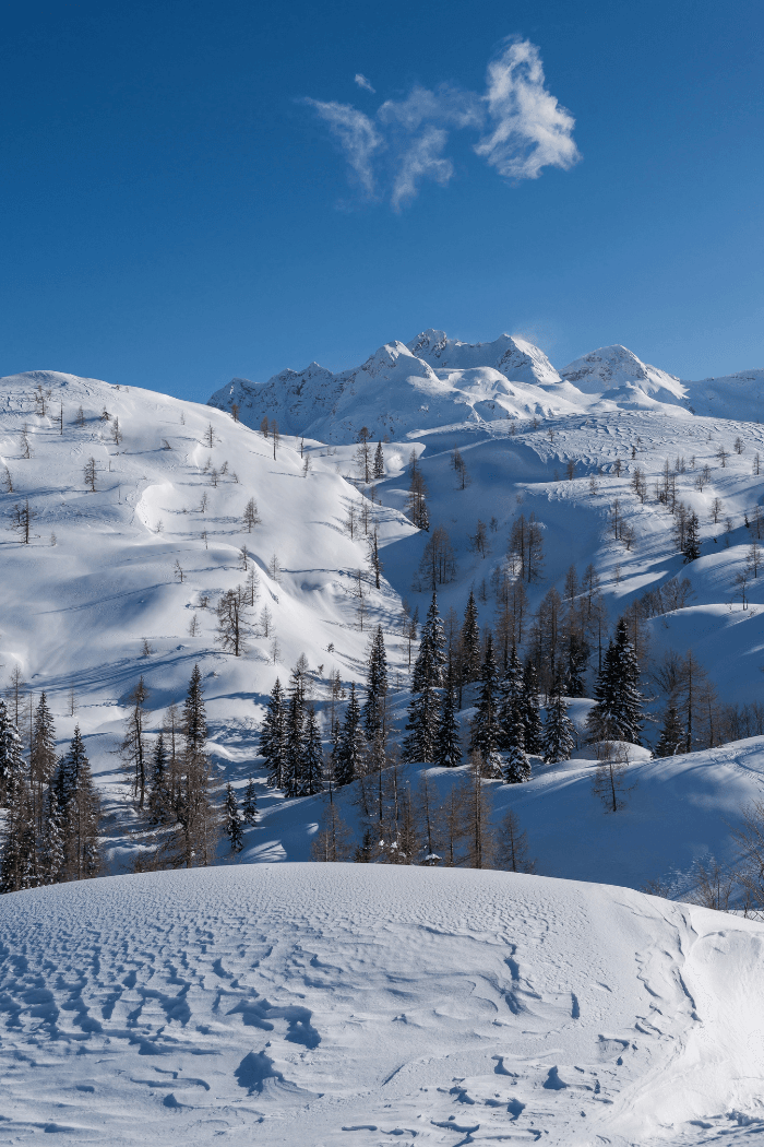 Snow covered hilltops and blue sky