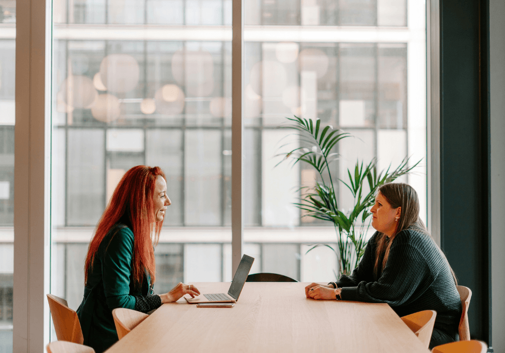 Woman sitting across from job candidate in interview setting