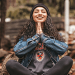 Woman sitting in woods doing meditation