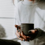 Close-up of woman holding grey ceramic mug