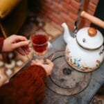 Old-fashioned white tea pot on stove
