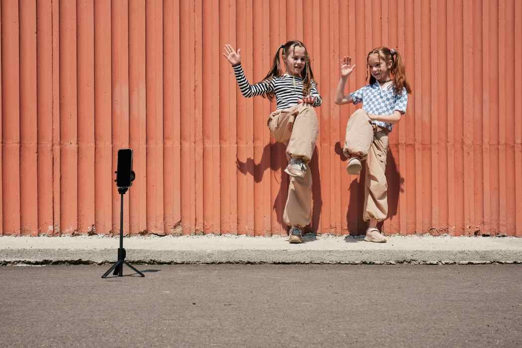 Two young girls recording TikTok dances