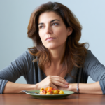 Woman in midlife sitting at table