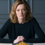 Woman in midlife sitting at table