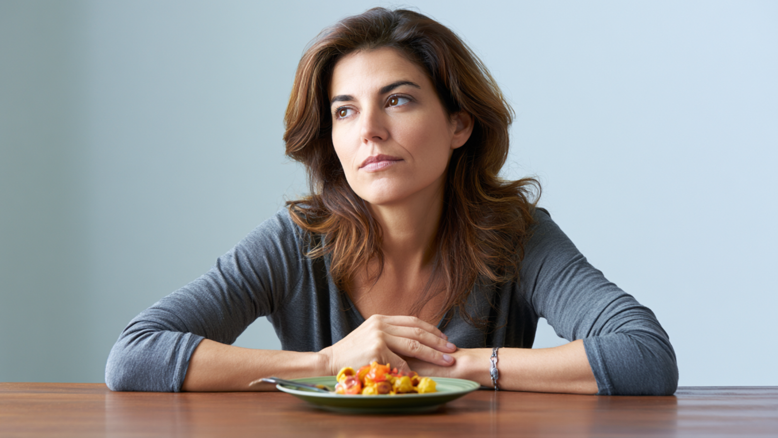 Woman in midlife sitting at table